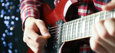 Guitarist playing a lead guitar solo on an electric guitar