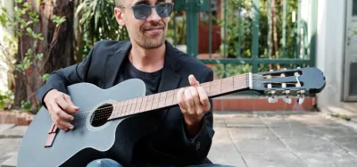Beginner practicing a riff on a single guitar string