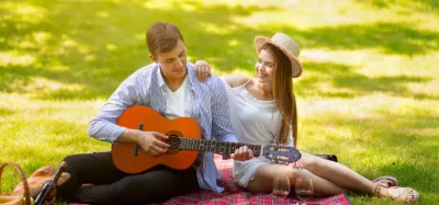 Person playing a romantic song on an acoustic guitar