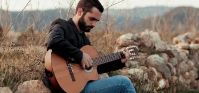 Person playing a Spanish classical guitar
