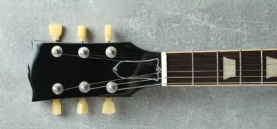 Close-up of a guitar nut at the headstock with strings seated in the slots