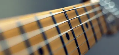 Close-up comparison of a fixed set-neck guitar joint and a bolt-on neck plate