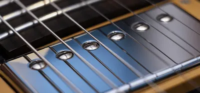 Close-up of guitar pickups on an electric guitar body