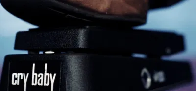 Wah pedal on a pedalboard wired in front of a guitar amplifier