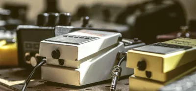 Guitar flanger effects pedal on a pedalboard showing its control knobs