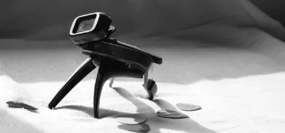 Guitar capo clamped across the fretboard of an acoustic guitar