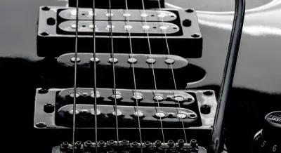 Electric guitar with multiple pickups mounted under the strings